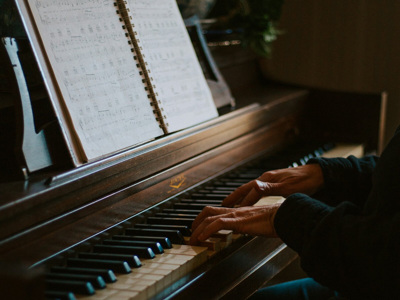 A teacher and student at the piano during a lesson